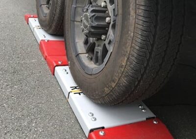 SUV positioned on wheel weigh pads for mobile vehicle weighing