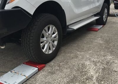 Close up of portable vehicle weigh pads measuring wheel weights